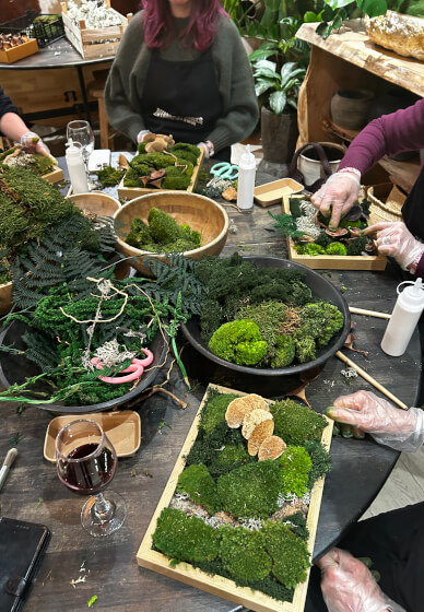 Moss frame workshop participants creating preserved moss art