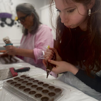 Ganache making and filling the shells in the mould.