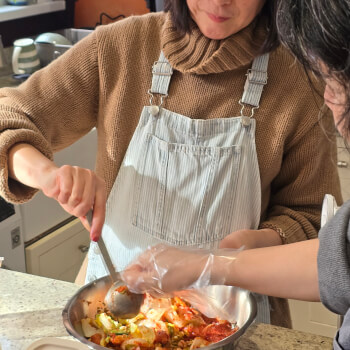 Mixing the cabbage in kimchi paste