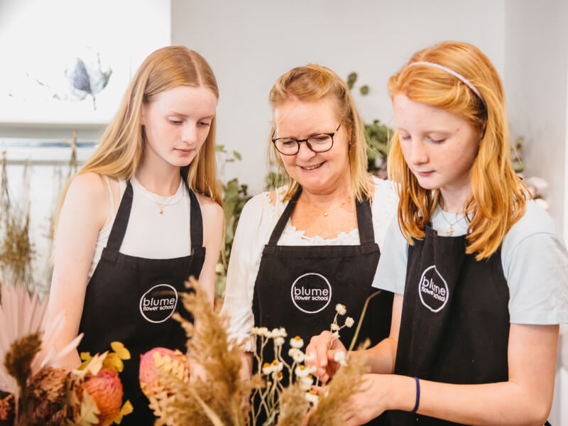 A mother and two daughters at a floristry class