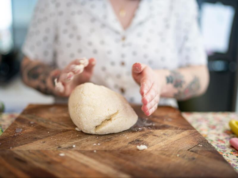 A person rolls a ball of gnocchi dough at a pasta making class.