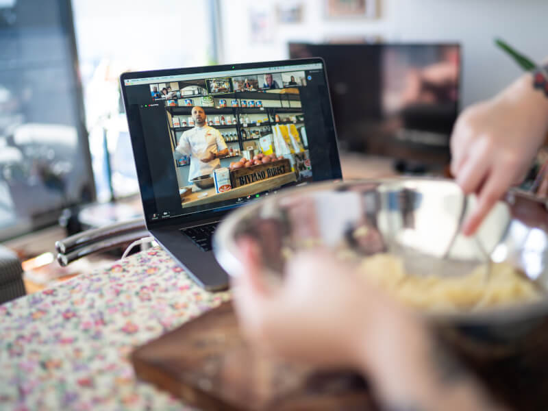 Woman mixes dough during a virtual cooking class.