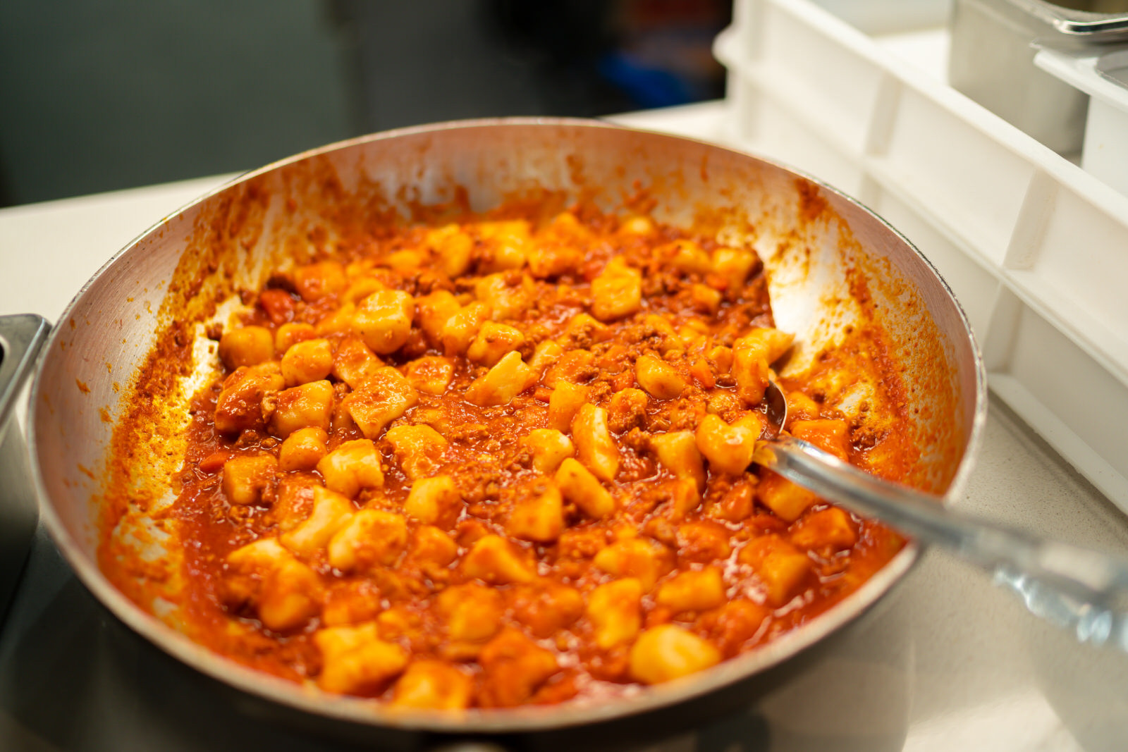A pan full of gnocchi and red sauce