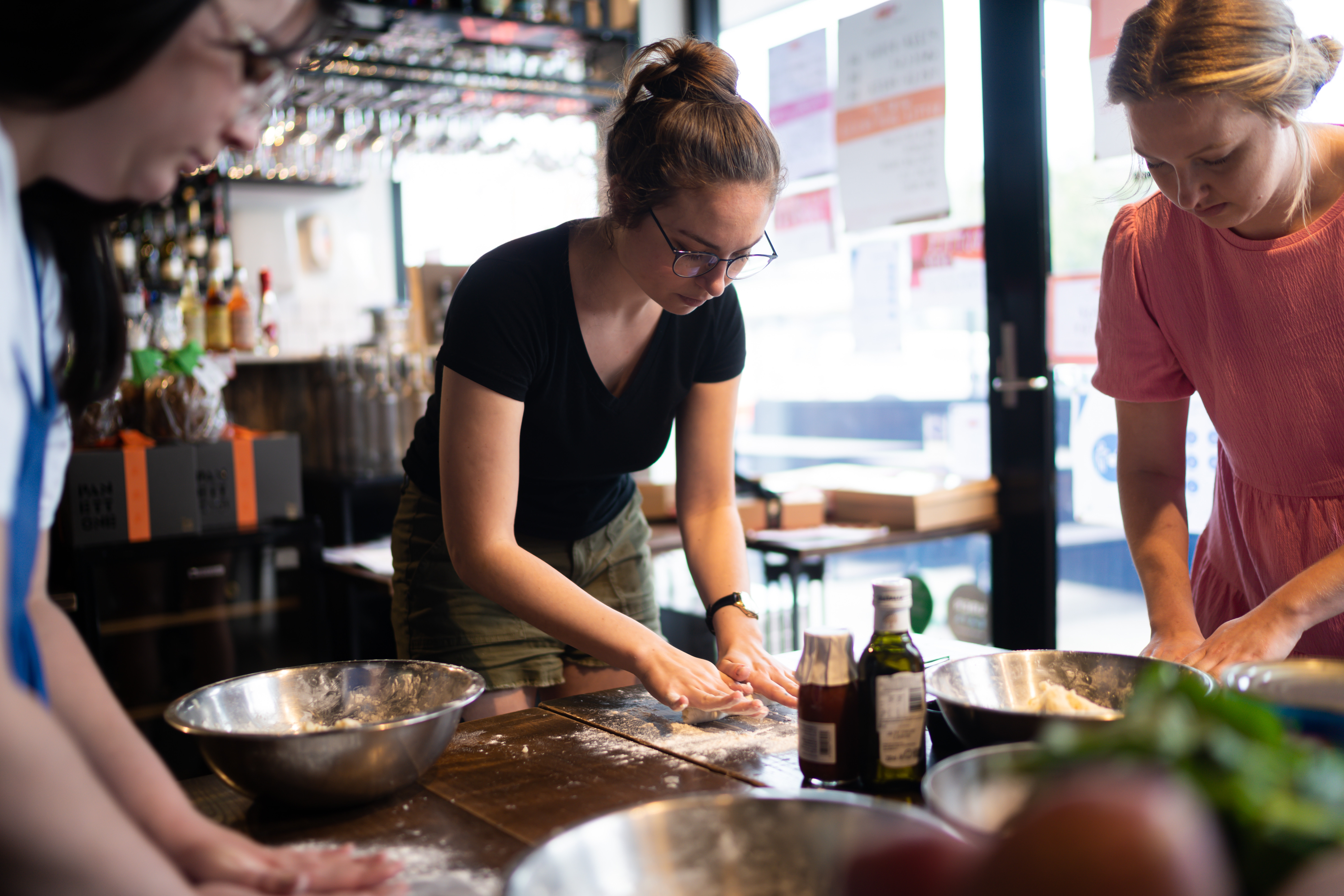 Students roll dough at a cookery class