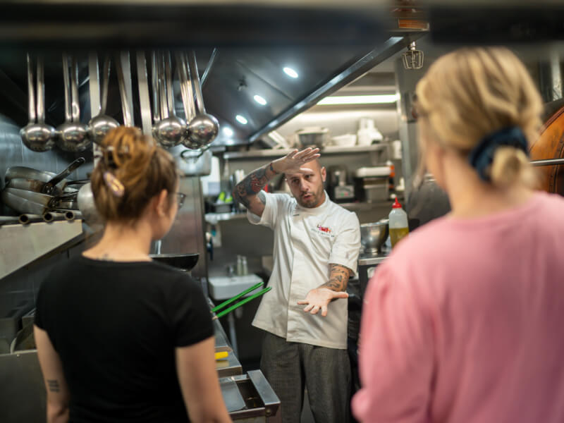 chef teaching a group of people at a cooking class