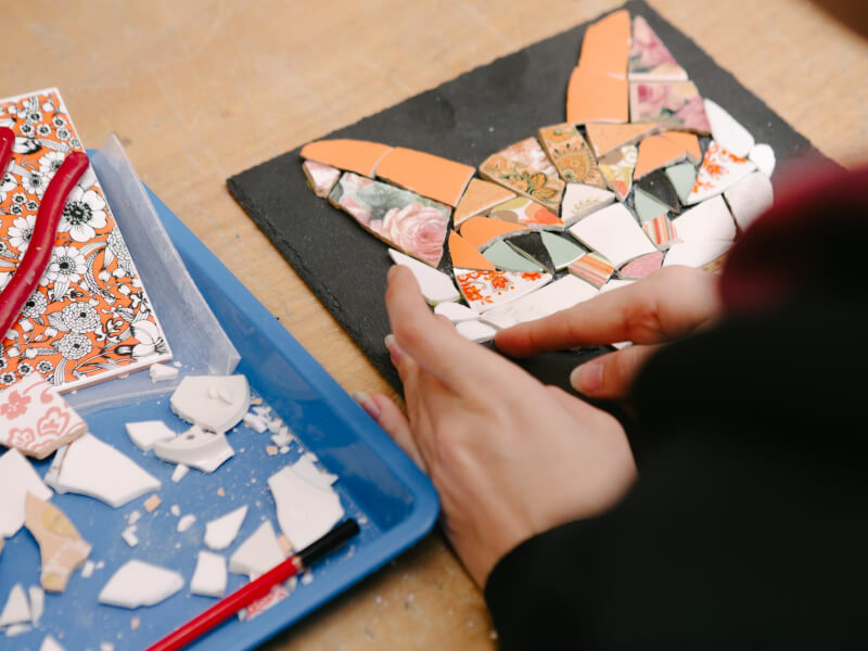 Close up of a nearly-complete mosaic of a ginger cat