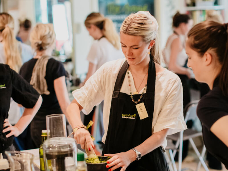 A group of students in aprons at a cooking class