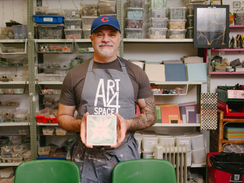 Man holding art at an art workshop in London