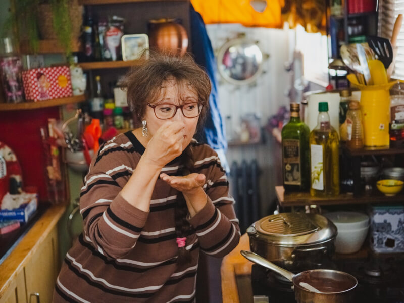 Woman tasting chocolate at a chocolate making class.