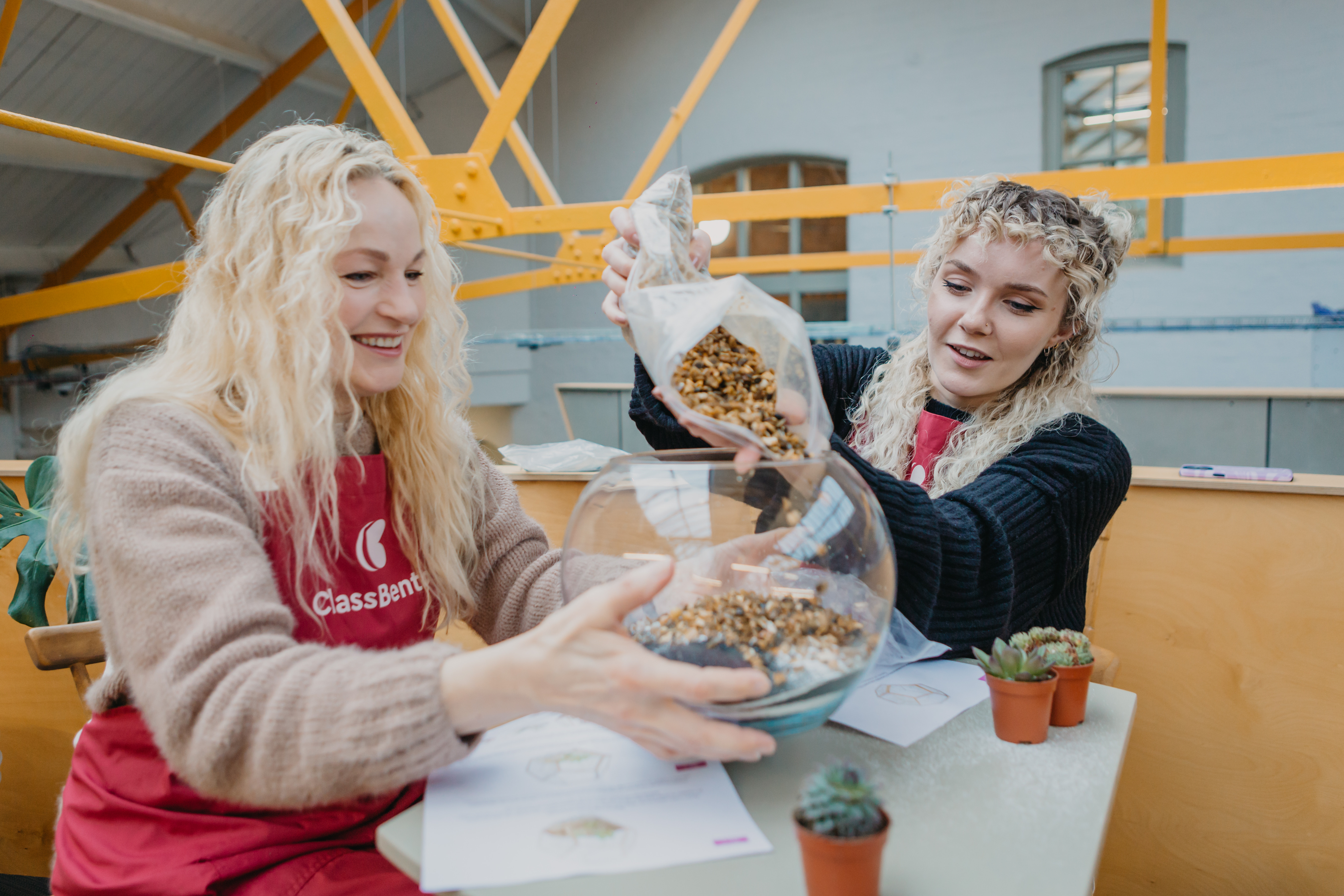 A mother and daughter at a terrarium making class