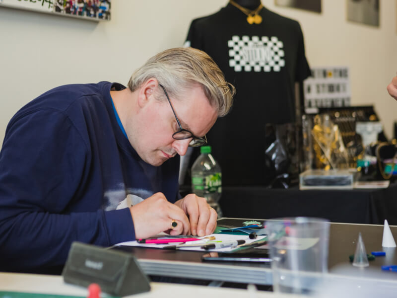 A man working at a bench during a jewellery making class