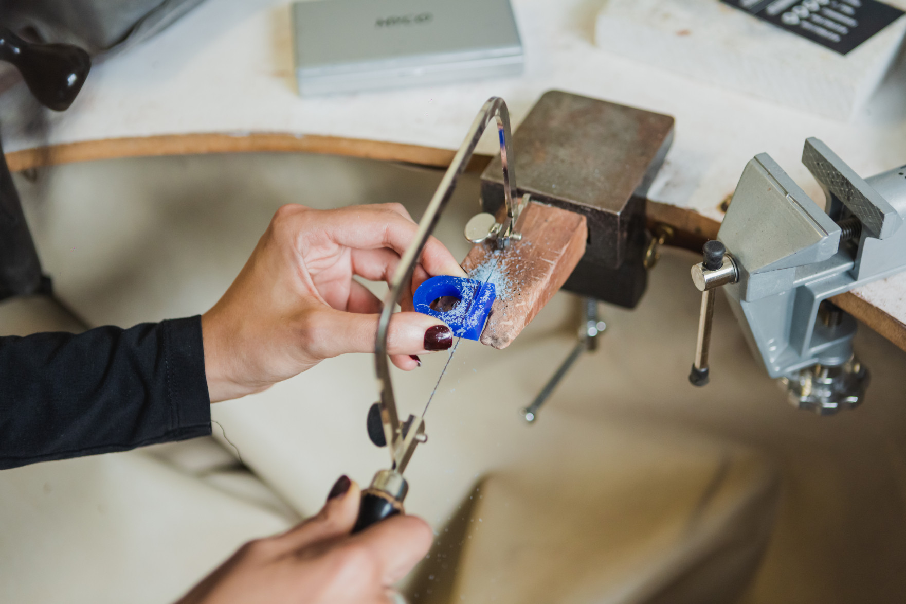 Close up of someone making a small piece of jewellery by hand