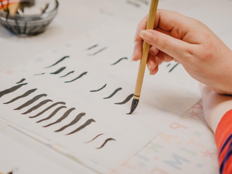 Lines being drawn at a Chinese lettering calligraphy class.