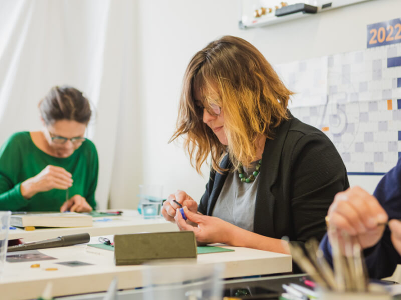 Two women making wax ring casts at a jewellery making class