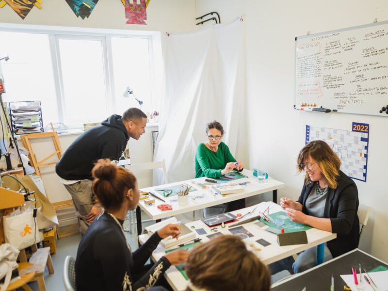 A group of people at a jewellery making workshop