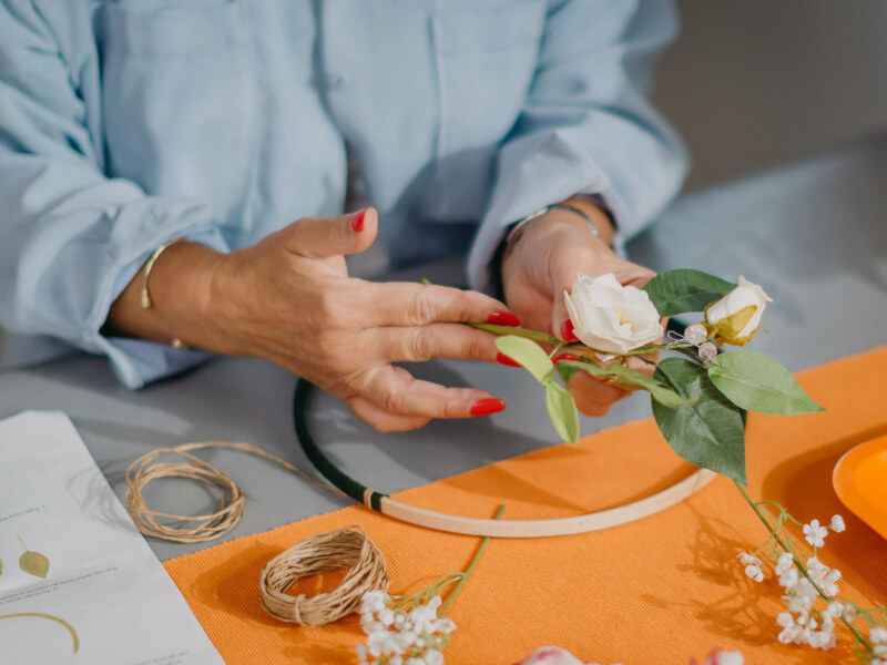 A woman making a homemade floral wreath