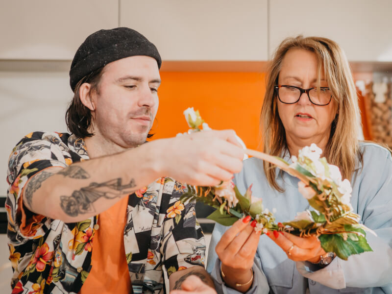 Two students arranging a floral wreath at a flower arranging class