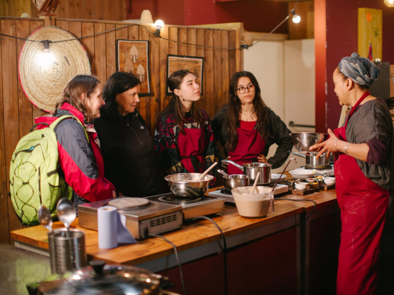 A group of students and their teacher at a cooking class