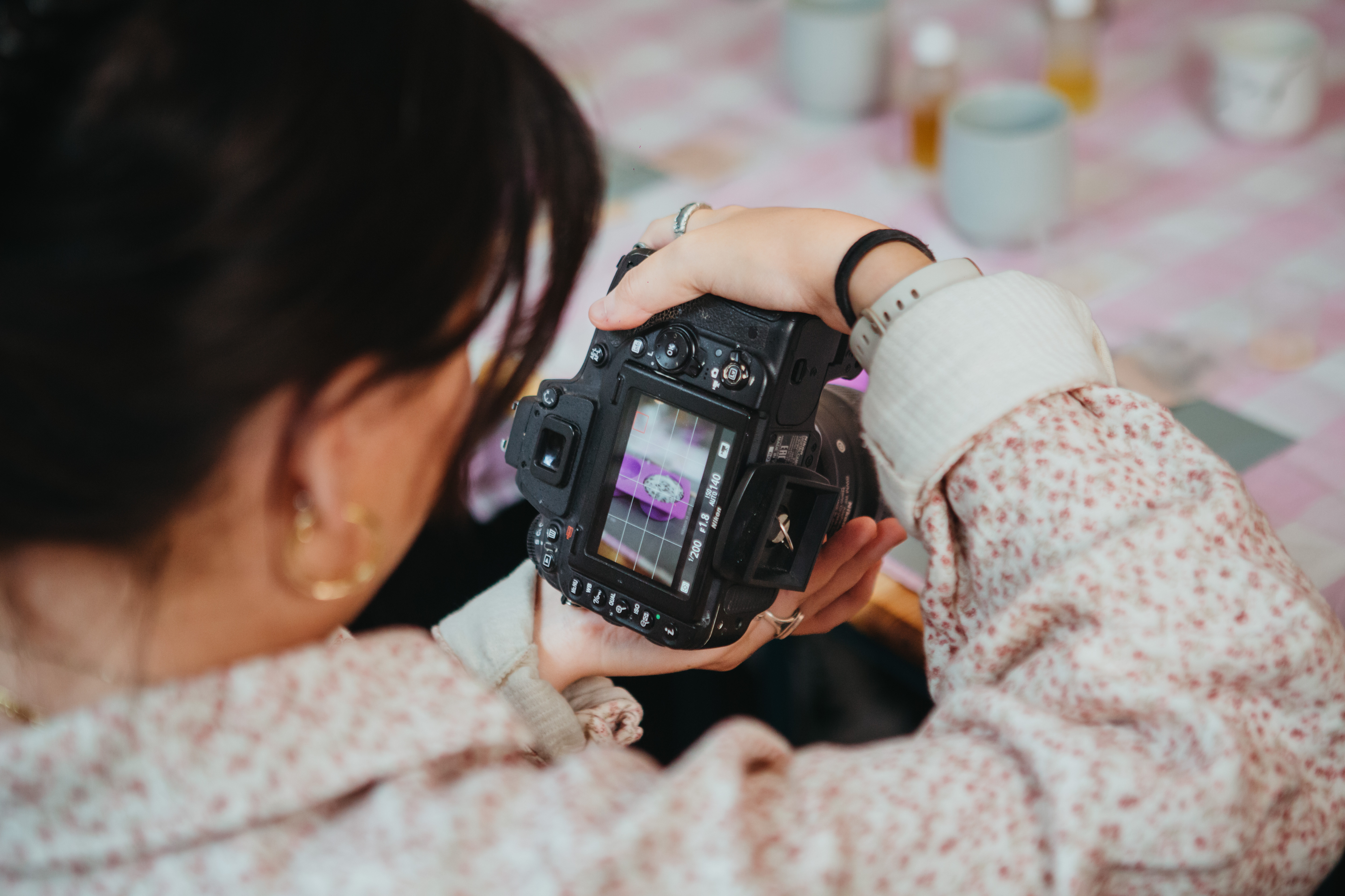Close up of a person checking the viewfinder of her DLSR camera