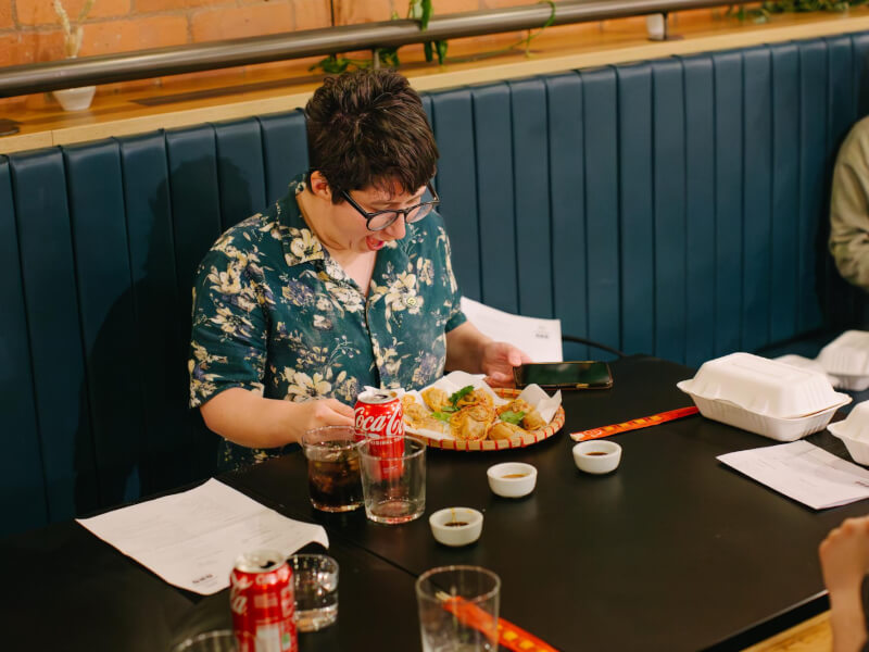 Person sitting at a table admiring the fresh dumplings they've made