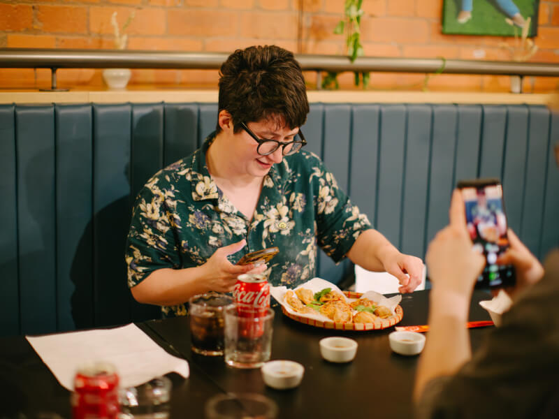 Someone using their iPhone to take a picture at a photography class.
