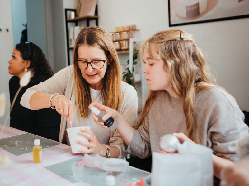Two women working together at a candle making class