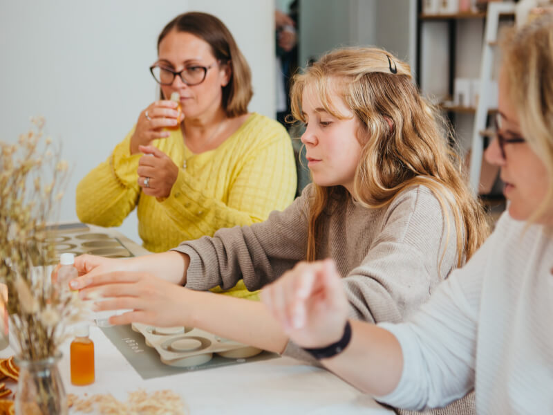 A group of women testing scents at a perfume making workshop