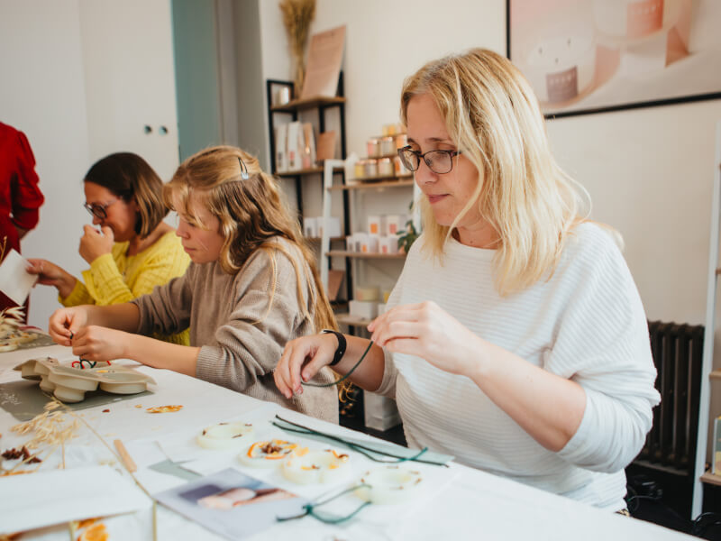 A woman making a Christmas themed soap at a workshop