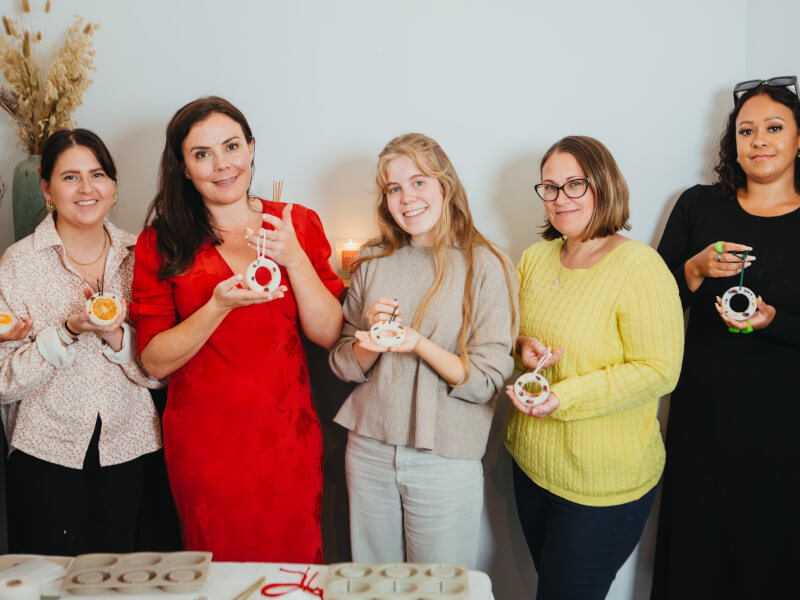 A group of women showing the Christmas candles they've made
