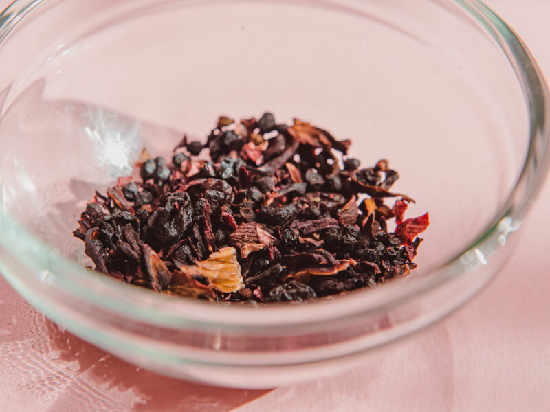 A glass bowl filled with loose leaf tea