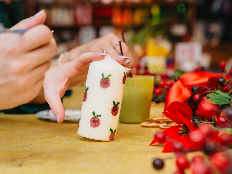 Close up of a Christmas themed painted candle