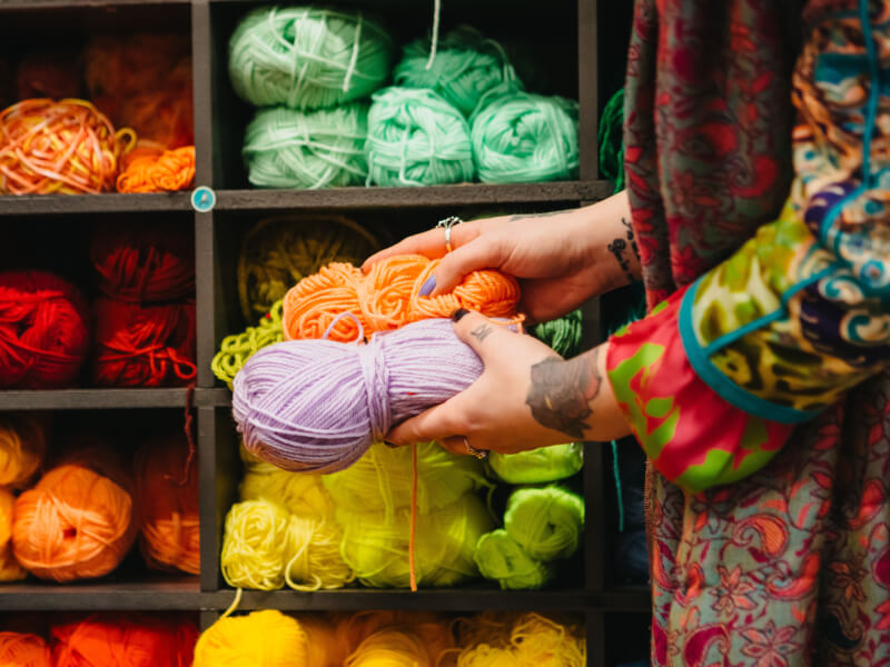 A collection of colourful yarn skeins that can be used in a textile art class.