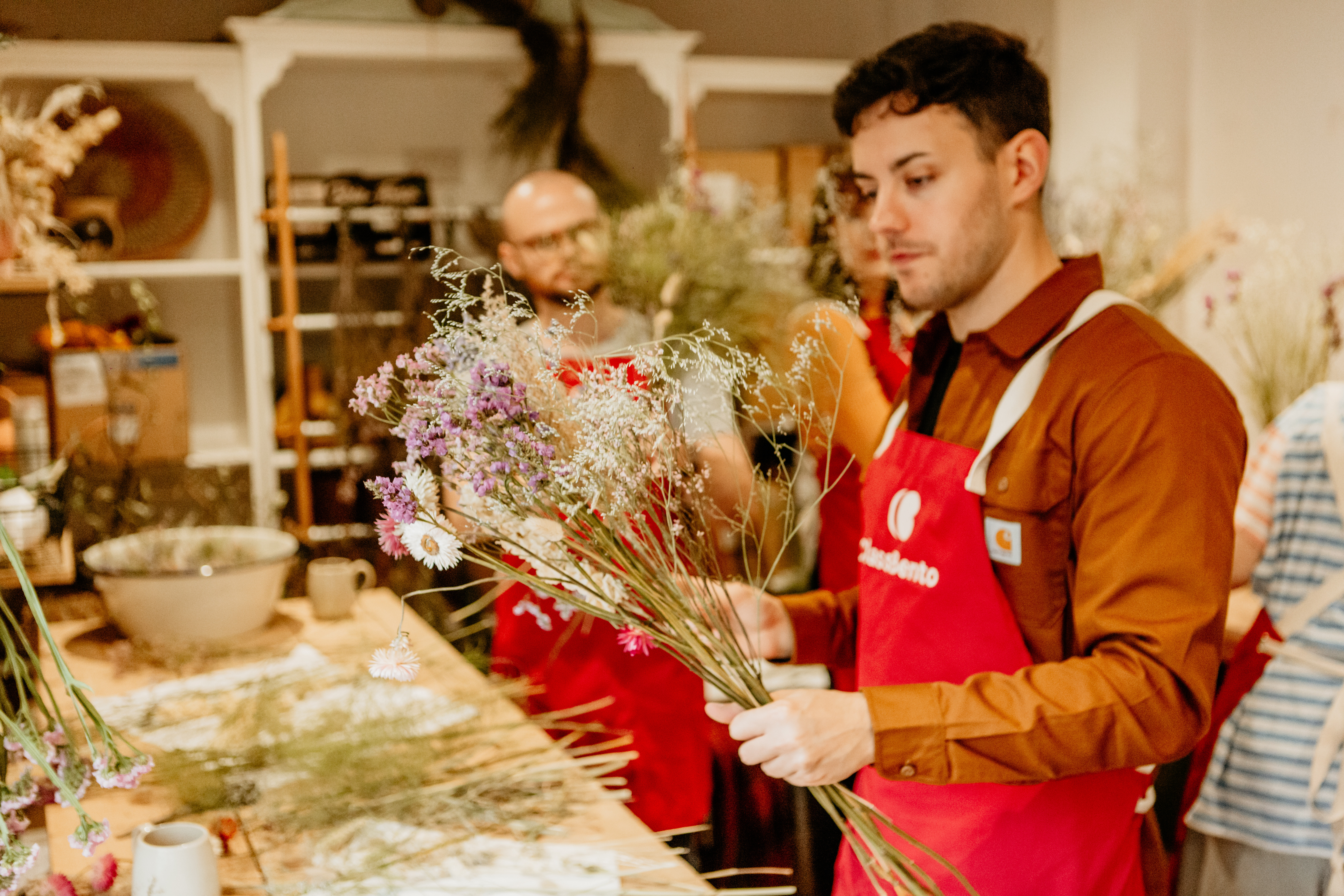 A group of students practising floristry at a flower workshop