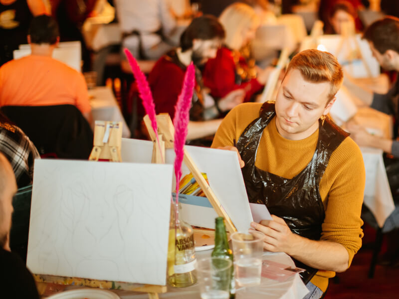 Person painting on an easel