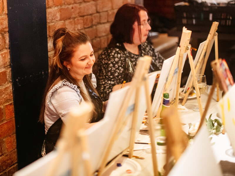 A hen party group at a painting class