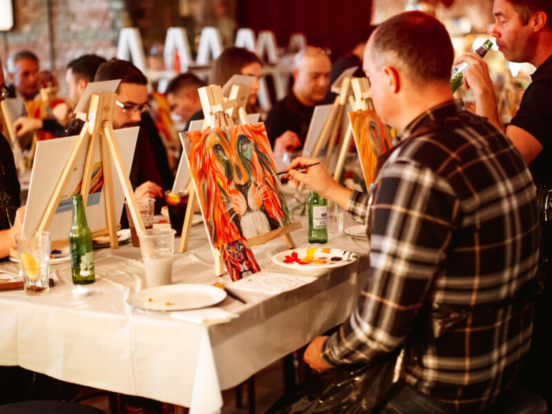 A group of people at a paint and sip workshop