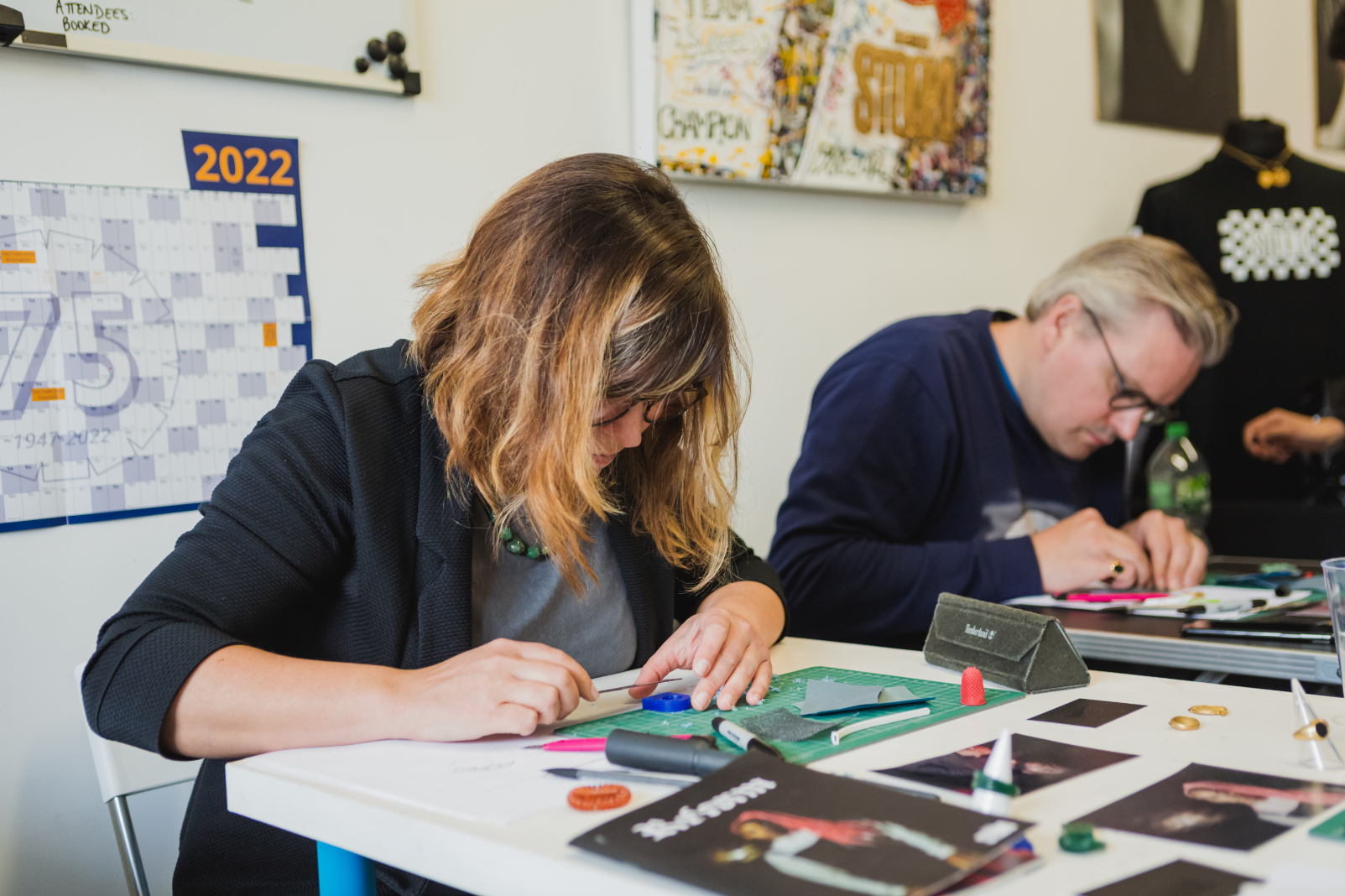 A man and woman making paper collages