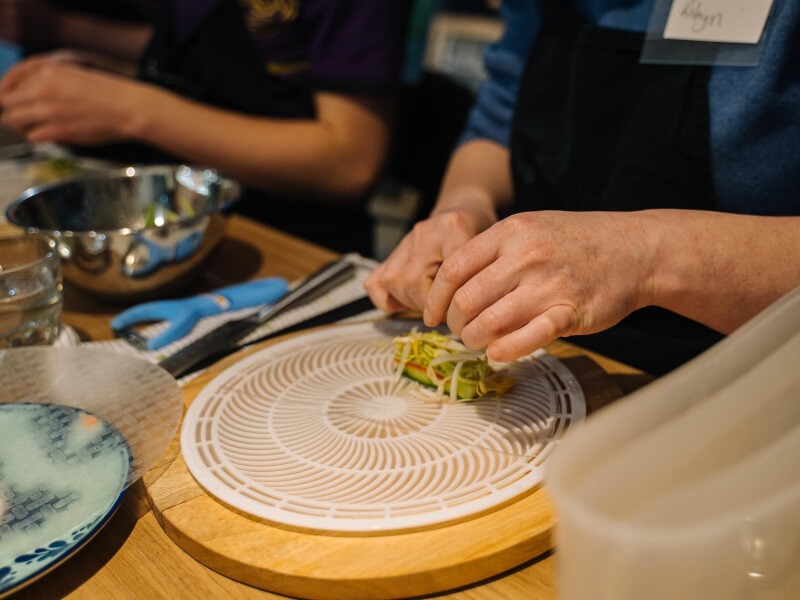 Students preparing a vegan dish at a cooking class