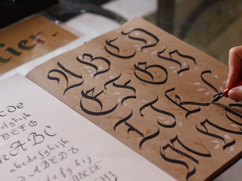 The alphabet written in a latin style font using brush lettering pens