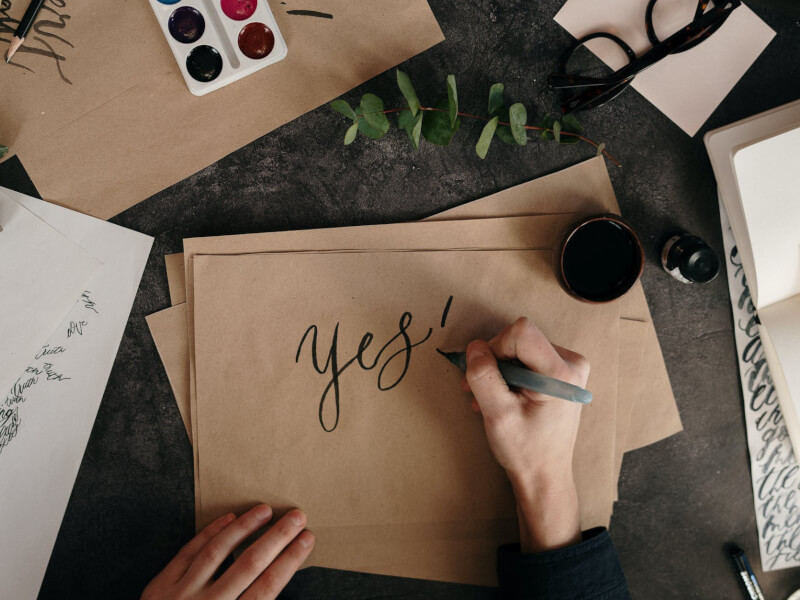 A woman practicing brush pen calligraphy.