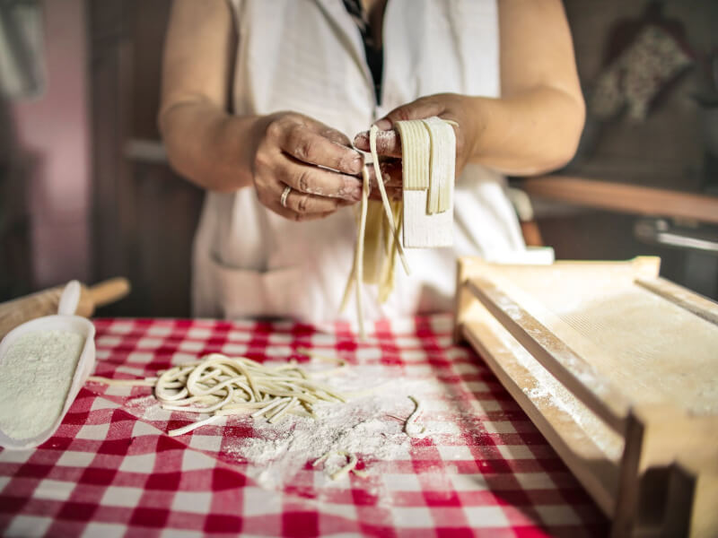 A woman creating Italian pasta.