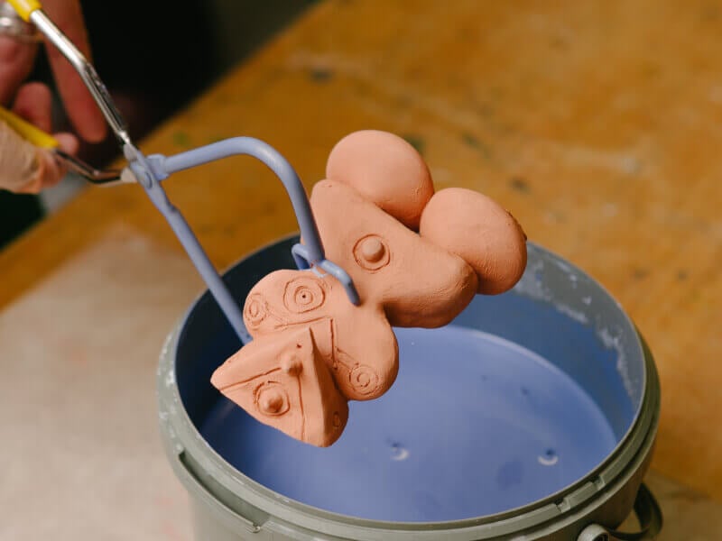 Ceramic being dipped in paint