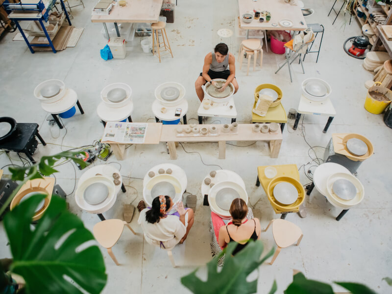 A top down view of multiple pottery wheels set up for a pottery course in London.