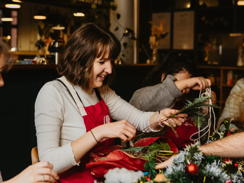 A group of women at a Christmas flower arranging class