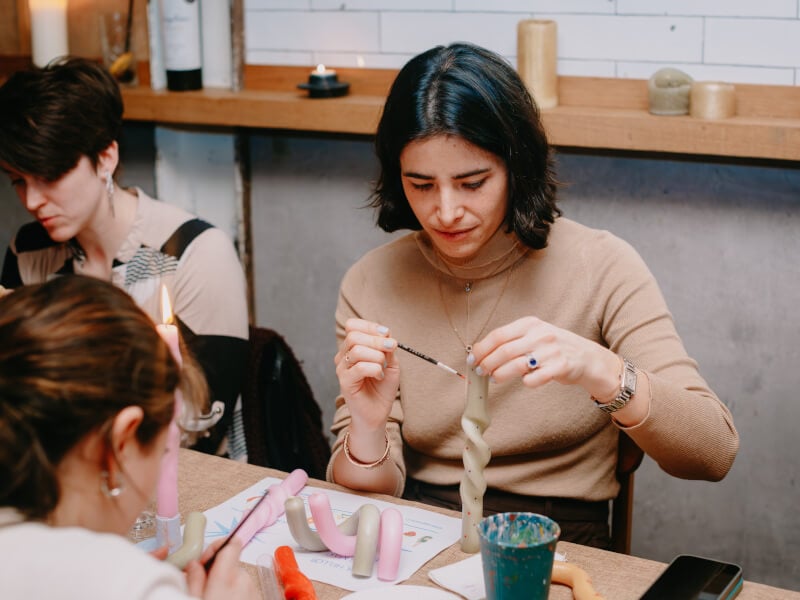 Woman painting a candle at a candle making class
