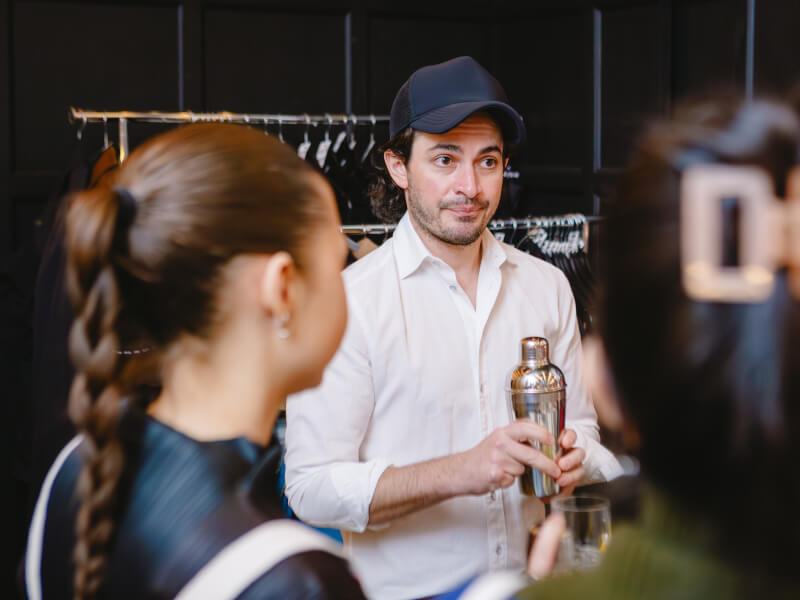 Students listening to their teacher at a cocktail making class