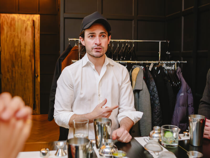 Students learn from their teacher at a cocktail making class