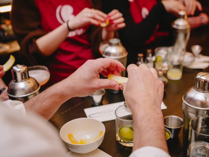 Close up of a person making a cocktail