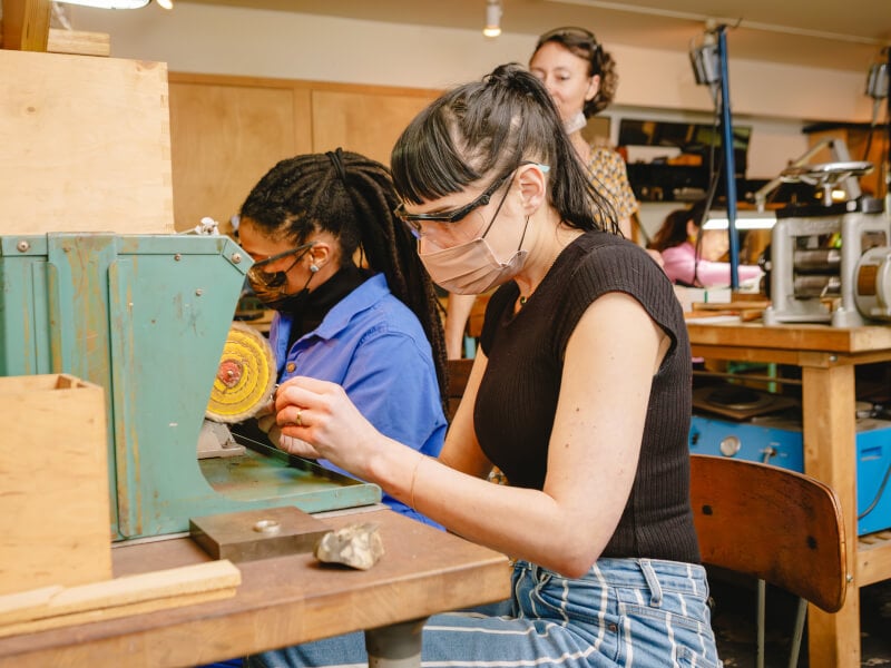 A couple creating together at a jewellery making class.