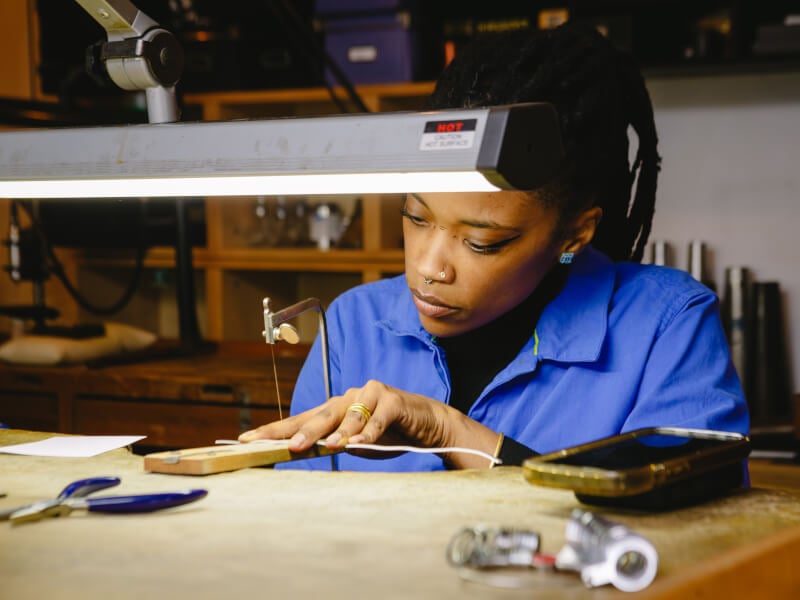 A student concentrating at a ring making class